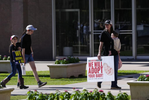 FILE - Pro-life demonstrators walk in the front of the Arizona Capitol prior to the vote on the proposed repeal of the state&rsquo;s near-total ban on abortions prior to winning approval from the state House on, April 24, 2024, in Phoenix. Democrats at the Arizona Legislature are expected to make a final push Wednesday, May 1, to repeal the state&rsquo;s long-dormant ban on nearly all abortions that a court said can be enforced. (AP Photo/Ross D.
