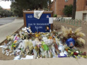 FILE - A memorial for University of Arizona professor Thomas Meixner is seen outside the school&rsquo;s Department of Hydrology and Atmospheric Sciences building in Tucson, Ariz., Oct. 14, 2022. A jury was seated Tuesday, May 7, 2024, for the trial of a former University of Arizona graduate student accused of fatally shooting Meixner in 2022 after he was banned from campus because of harassment complaints.