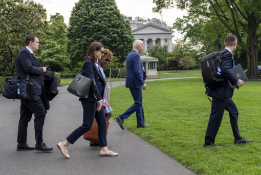 President Joe Biden, second from right, walks with aides to Marine One for departure from the South Lawn of the White House, Wednesday, May 8, 2024, in Washington. Biden is headed to Wisconsin and Chicago.