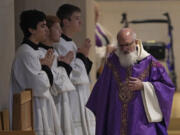 Rev. Gabriel Landis officiates a Catholic Mass at Benedictine College Sunday, Dec. 3, 2023, in Atchison, Kan.
