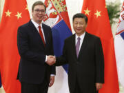 FILE- Serbian Prime Minister Aleksandar Vucic, left, and Chinese President Xi Jinping pose for photographers as they meet at the Great Hall of the People in Beijing Tuesday, May 16, 2017. The two countries have a long history of friendship, particularly since 1999, when NATO bombed the Chinese embassy in Belgrade, killing three Chinese nationals, during the air war to end Serbia&rsquo;s brutal crackdown on ethnic Albanian separatists in Kosovo.