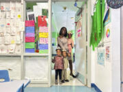 This March 2024 photo provided by The Hechinger Report shows Derrika Richard as she walks her three youngest children to their child care classrooms at Clara&rsquo;s Little Lambs in New Orleans.