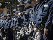 NYPD officers from the Strategic Response Group form a wall of protection around Deputy Commissioner of Legal Matters Michael Gerber and Deputy Commissioner of Operations Kay Daughtry, not in the picture, during a press conference regarding the ongoing pro-Palestinians protest encampment at Columbia University in New York on Monday, April 22, 2024.