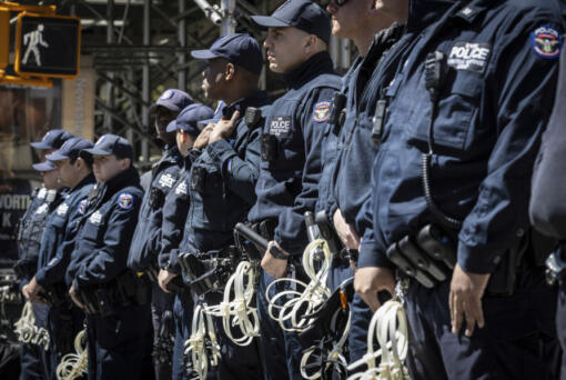 NYPD officers from the Strategic Response Group form a wall of protection around Deputy Commissioner of Legal Matters Michael Gerber and Deputy Commissioner of Operations Kay Daughtry, not in the picture, during a press conference regarding the ongoing pro-Palestinians protest encampment at Columbia University in New York on Monday, April 22, 2024.