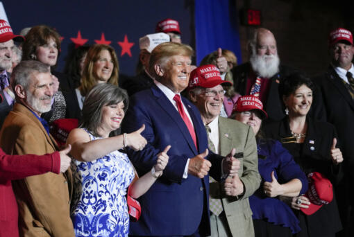 FILE - Former President Donald Trump poses for a photo with supporters after speaking at a campaign event Thursday, April 27, 2023, in Manchester, N.H. He&rsquo;s a criminal defendant, a businessman and a politician. But to his most loyal supporters, Donald Trump will always be Mr. President. When it comes to signaling our political loyalities, language can be just as telling as a MAGA cap, offering a simple by subtle reminder of the false election claims that continue to reverberate online, as well as the polarization that has gripped our politics and divided our people.