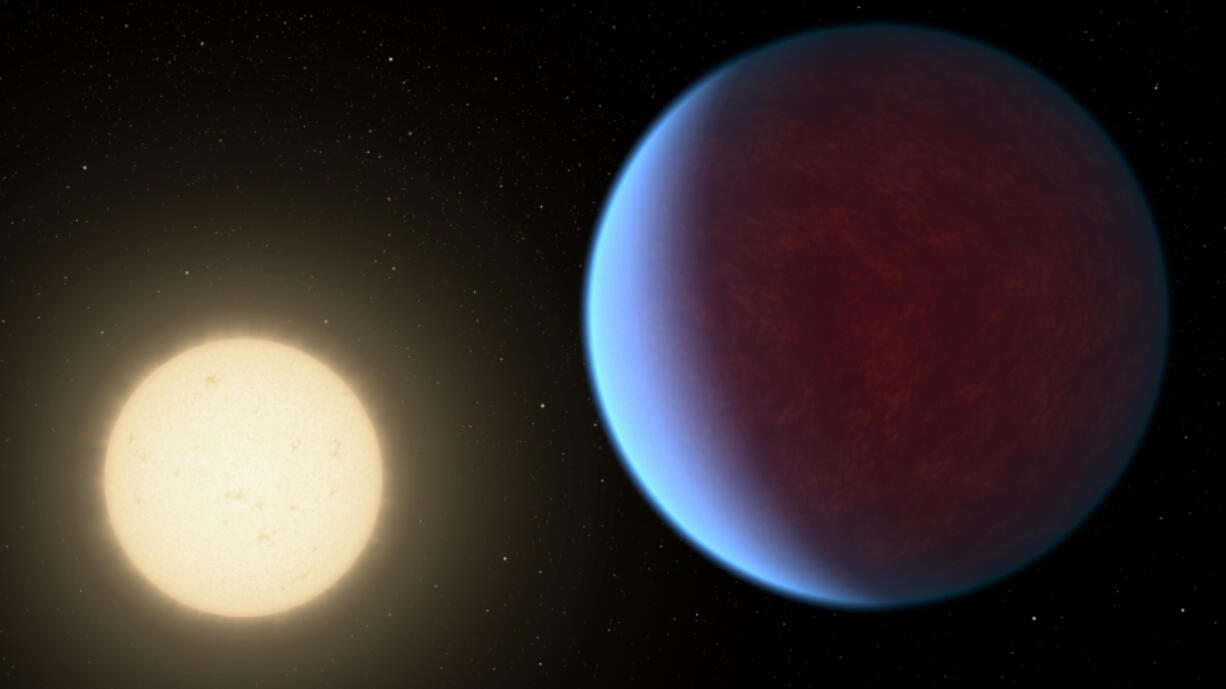 This illustration provided by NASA in 2017 depicts the planet 55 Cancri e, right, orbiting its star. A thick atmosphere has been detected around the planet, which is twice as big as Earth in a solar system about 41 light-years away, researchers reported Wednesday.