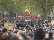 Thousands of people march during the May Day demonstration, Wednesday, May 1, 2024 in Paris. Thousands of protesters marched through the French capital, seeking better pay and working conditions. Pro-Palestinian groups and anti-Olympics activists joined the rally in Paris which will host the Summer Games in less than three months.