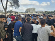 Mourners carry the bodies of members of the Abu Taha family who were killed in an Israeli airstrike, during their funeral at Al-Salam cemetery, east of Rafah, Gaza Strip. Monday, April 29, 2024.