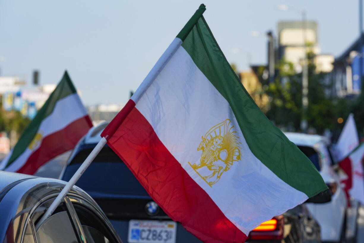 A caravan of vehicles rides while flying the Lion and Sun flag along Westwood Boulevard, in the so-called &quot;Tehrangeles&quot; neighborhood in the Westwood district of Los Angeles, Monday, May 20, 2024. The Lion and Sun flag was Iran&#039;s official flag for centuries until the 1979 revolution. The ancient Persian flag continues to be used by the Iranian diaspora, monarchists and opposition groups as a symbol of Iran&#039;s pre-Islamic heritage and resistance against the Islamic Republic.