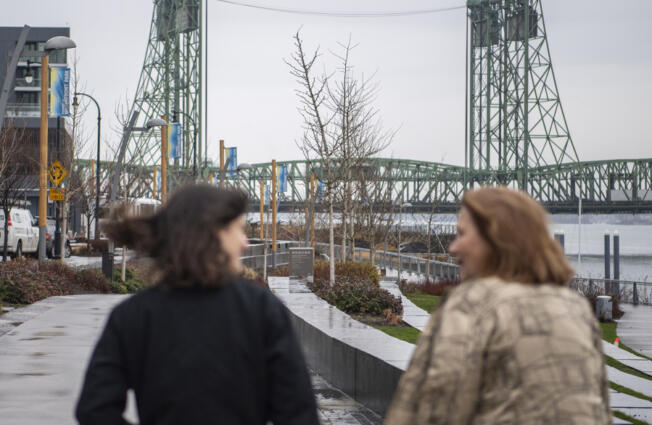 The Interstate 5 Bridge rises above the Columbia River as Rep. Marie Gluesenkamp Perez, D-Skamania, left, and Vancouver Mayor Anne McEnerny-Ogle talk Jan. 13, 2023, during a tour of key infrastructure projects in Perez&rsquo;s district.