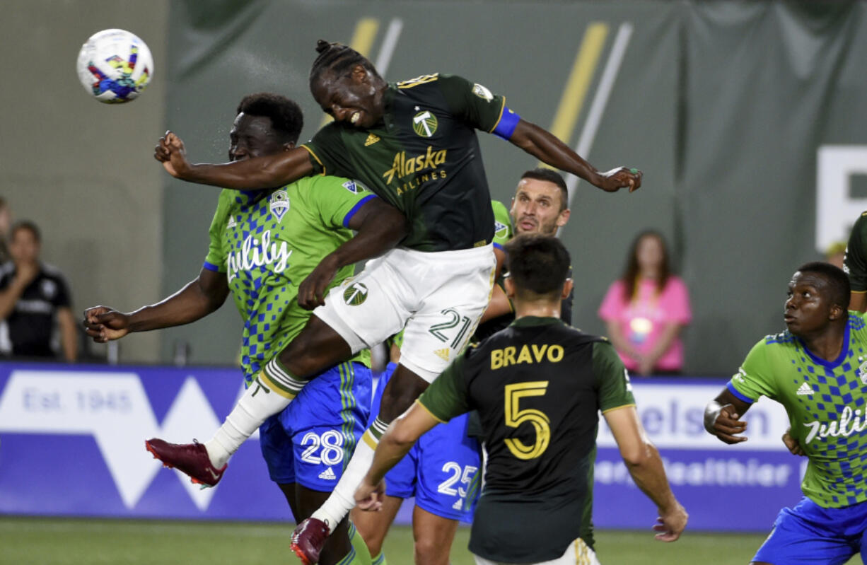 FILE - Seattle Sounders defender Yeimar G&oacute;mez (28) and Portland Timbers midfielder Diego Char&aacute; (21) go up for a ball during the second half of an MLS soccer match in Portland, Ore., Friday, Aug. 26, 2022. Chara&rsquo;s legacy in Major League Soccer isn&rsquo;t just the fouls that he&rsquo;s so frequently called for. It&rsquo;s his longevity.