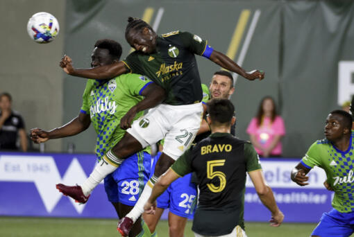 FILE - Seattle Sounders defender Yeimar G&oacute;mez (28) and Portland Timbers midfielder Diego Char&aacute; (21) go up for a ball during the second half of an MLS soccer match in Portland, Ore., Friday, Aug. 26, 2022. Chara&rsquo;s legacy in Major League Soccer isn&rsquo;t just the fouls that he&rsquo;s so frequently called for. It&rsquo;s his longevity.