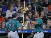 Seattle Mariners&#039; Cal Raleigh (29) is congratulated by Julio Rodr&iacute;guez, right, after hitting a go-ahead solo home run during the ninth inning of a baseball game against the Houston Astros Sunday, May 5, 2024, in Houston. (AP Photo/Kevin M.