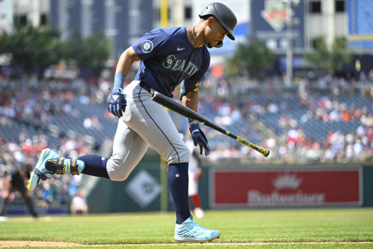 Seattle Mariners Julio Rodriguez runs to first on an RBI single during the eighth inning of a baseball game against the Washington Nationals, Sunday, May 26, 2024, in Washington.
