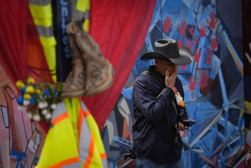 Roberto Marquez, an artist from Dallas, speaks during an interview with the Associated Press at a memorial site to honor the construction workers who lost their lives in the collapse of the Francis Scott Key Bridge in Baltimore, Thursday, April 25, 2024.
