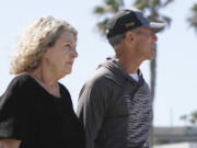 In this image taken from video, Australia&rsquo;s Debra Robinson stands with her husband Martin, following a media conference on the beach in San Diego, Tuesday, May 7, 2024 following the deaths in Mexico of their two sons during a surfing trip. The sons, Callum and Jake, and U.S. friend Jack Carter Rhoad, were allegedly killed by car thieves in Baja California, across the border from San Diego, somewhere around April 28 or 29.