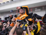 McLaren driver Lando Norris, of Britain, is lifted after winning the Miami Formula One Grand Prix auto race Sunday, May 5, 2024, in Miami Gardens, Fla.
