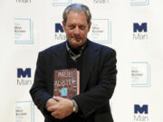 Author Paul Auster poses with his book &ldquo;4321&rdquo; on Oct. 16, 2017 in London. Auster died this week at age 77.