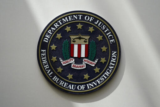 FILE - An FBI seal is seen on a wall on Aug. 10, 2022, in Omaha, Neb. The FBI says scammers stole more than $3.4 billion from older Americans last year. An FBI report released Tuesday shows a rise in losses through increasingly sophisticated tactics to trick the vulnerable into giving up their life savings.