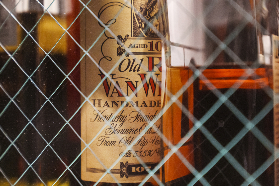 A bottle of Old Pappy Van Winkle bourbon is shown behind glass doors at a whiskey bar March 4, 2023.