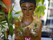 A statue is seen at Chiang Rai Thai Cuisine, a family restaurant run by members of the Iu Mien community, on Tuesday, April 30, 2024, in Troutdale, Ore. There is a sizeable Iu Mien community in Portland and its suburbs, with a Buddhist temple and Baptist church, active social organization, and businesses and restaurants.