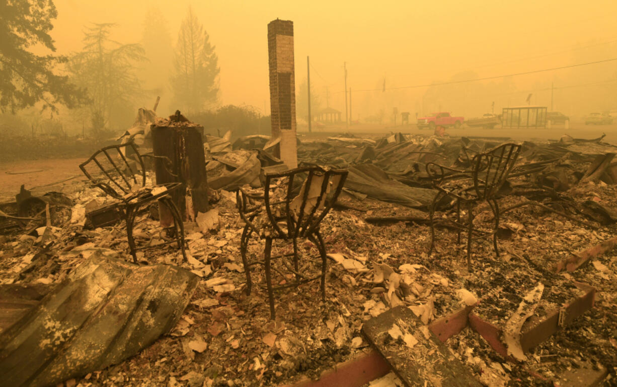 FILE - Chairs stand at the Gates post office in the aftermath of a fire in Gates, Ore., Sept 9, 2020. Oregon utility regulators have rejected a request from PacifiCorp that sought to limit its liability in wildfire lawsuits. KGW reports that the proposal would have limited the company&rsquo;s wildfire liability to just economic damages.