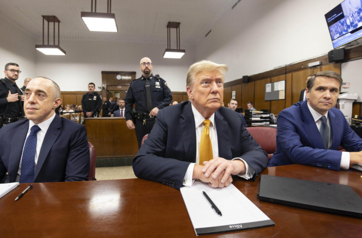Former President Donald Trump sits in court with his attorneys Emil Bove, left, and Todd Blanche at Manhattan criminal court, Tuesday, May 21, 2024 in New York.
