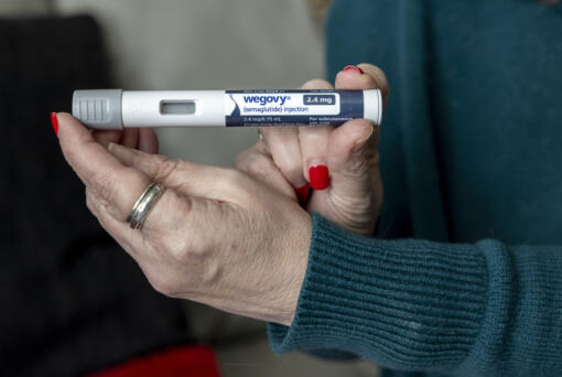 FILE - Donna Cooper holds up a dosage of Wegovy, a drug used for weight loss, at her home in Front Royal, Va., on Friday, March 1, 2024. &ldquo;To me, it&rsquo;s a help, it&rsquo;s an aid,&rdquo; says Cooper, 62, who lost nearly 40 pounds in nine months using Wegovy along with diet and exercise. &ldquo;At some point you have to come off of them.