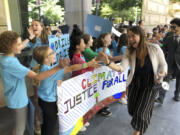 FILE - Kelsey Juliana, of Eugene, Ore., a lead plaintiff who is part of a lawsuit by a group of young people who say U.S. energy policies are causing climate change and hurting their future, greets supporters outside a federal courthouse, June 4, 2019, in Portland, Ore. A 9th U.S. Circuit Court of Appeals panel on Wednesday, May 1, 2024, rejected a long-running lawsuit brought by young Oregon-based climate activists who argued that the U.S. government&rsquo;s role in climate change violated their constitutional rights.