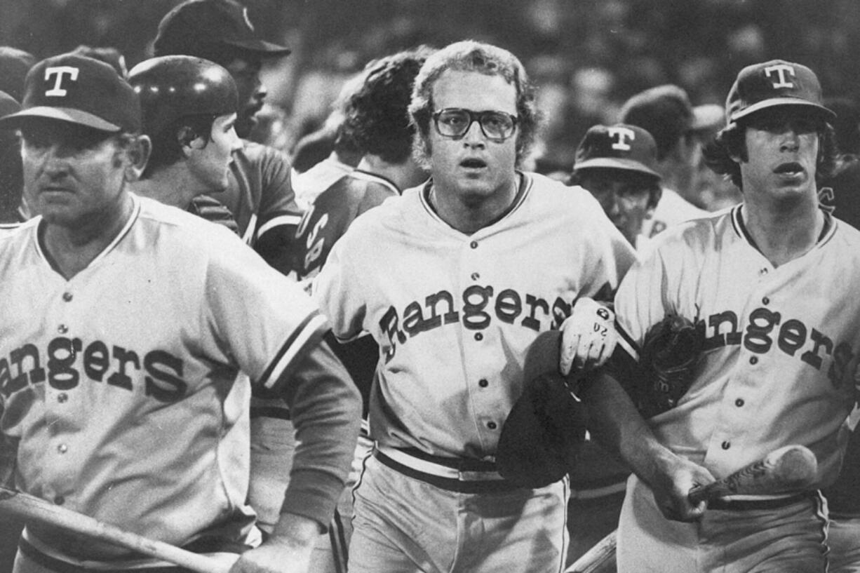 FILE - In this image provided by Special Collections, Cleveland State University, Texas Rangers&#039; Jeff Burroughs, center, runs off the field with his teammates during the Beer Night melee at Cleveland Stadium, June 4, 1974, in Cleveland. The Cleveland Indians forfeited the baseball game to the Rangers after fans, fueled by 10-cent beers, stormed the field in the ninth inning.