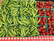 Sweet peas and strawberries are for sale at Camas Farmer&rsquo;s Market in downtown Camas in 2022.