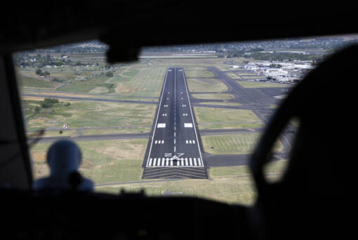 A plane can be seen from the cockpit of a 757 research plane sitting at the beginning of the runway at the airport in Yakima, Washington, on Friday, June 7, 2024. At right is Alaska Airlines pilot Jennifer Kelsey. (Ellen M.
