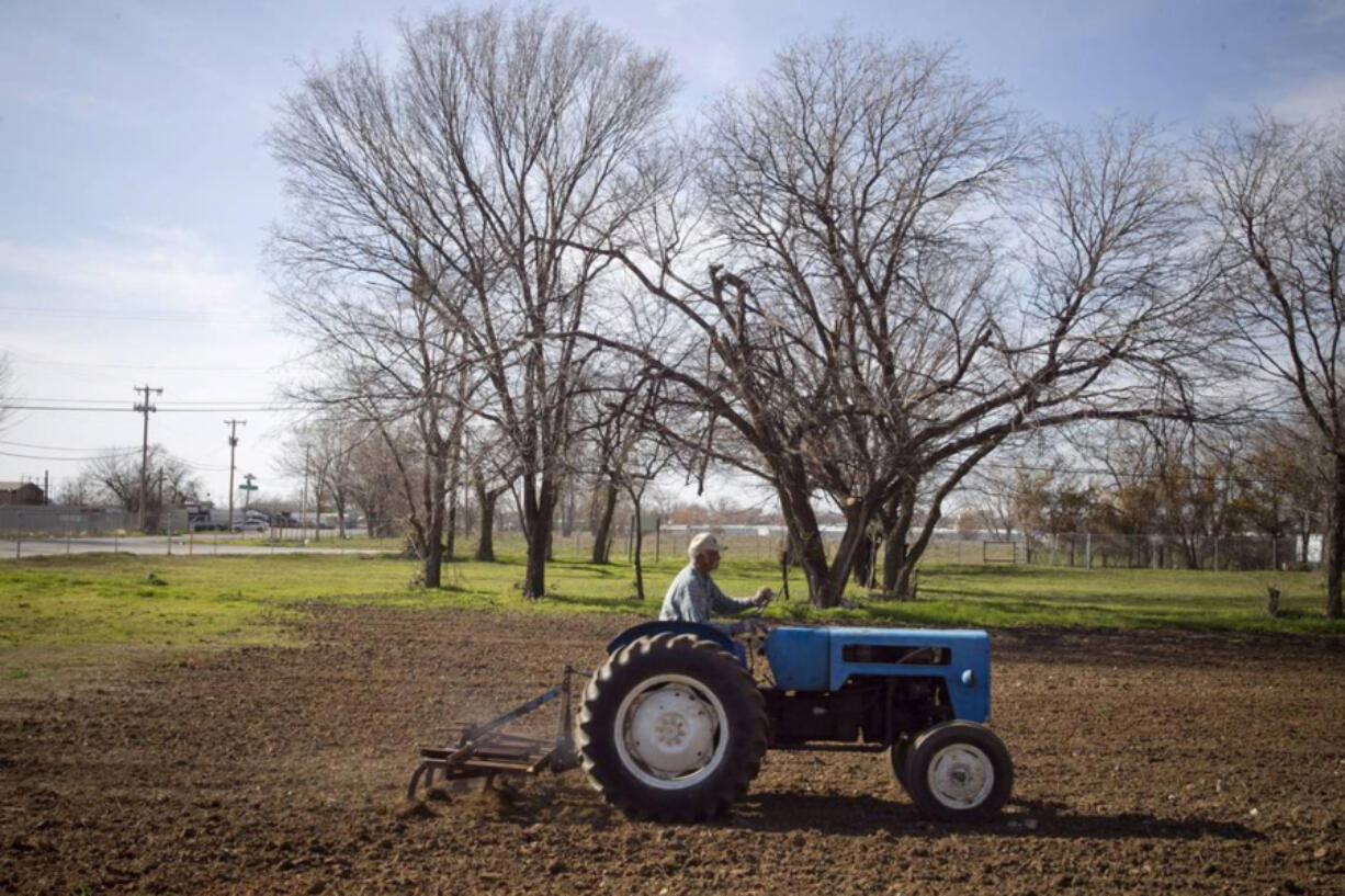 Historic Black settlements across North Texas are disappearing. Garden of Eden, a small neighborhood straddling Fort Worth and Haltom City, dates back before the Army established Fort Worth in 1849. In this 2012 photo, Delbert Sanders plows a garden next to the Valley Baptist Church in the neighborhood.