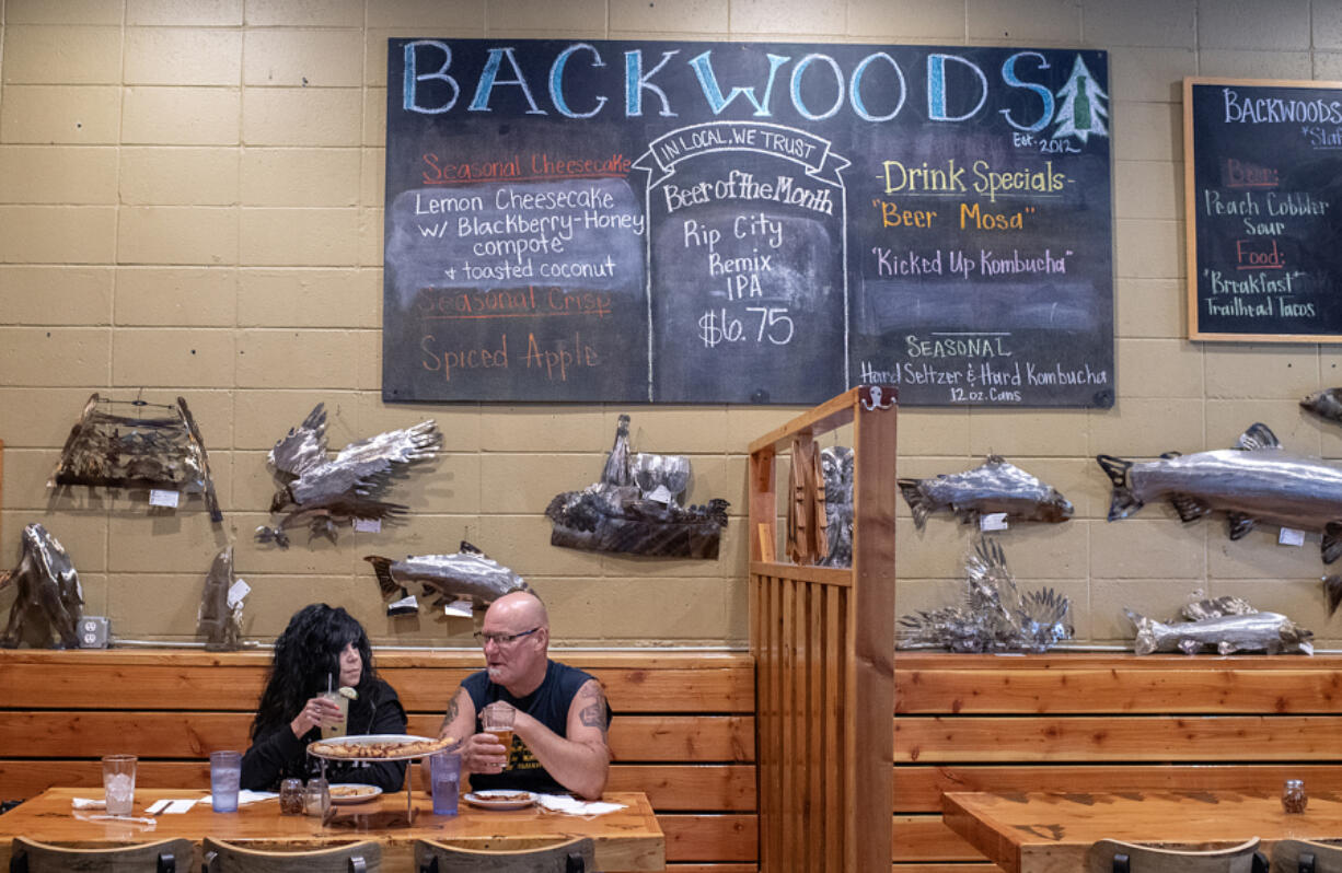 Dina and Mike Buchanan of Longview stop by Backwoods Brewing Company in Carson for lunch at the tail end of a camping trip in May. Backwoods opened a third pub last year in Hillsboro, Ore., plus a small fleet of cabins in Carson.