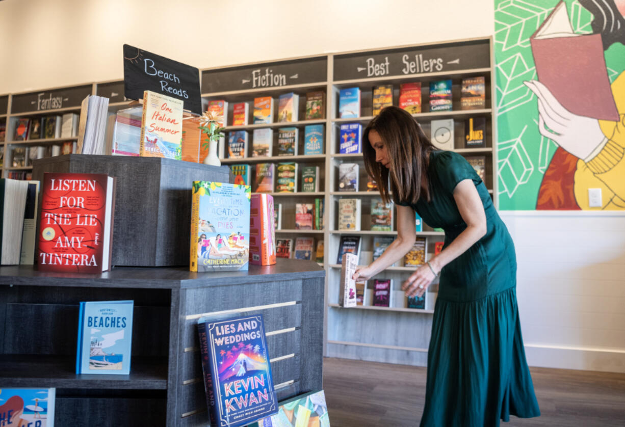 Eden Wade arranges books on a display. Her bookstore, Autumn Leaf Books, is the latest of six Clark County stores to open since 2021.