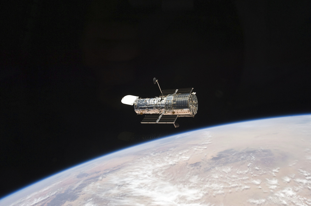 This photo provided by NASA, an STS-125 crew member aboard the Space Shuttle Atlantis captured this image of NASA’s Hubble Space Telescope on May 19, 2009. NASA said the telescope slipped into a hibernating state more than a week ago when one of its gyroscopes _ part of the pointing system _ malfunctioned. The same device has been acting up for months and disrupting scientific operations.