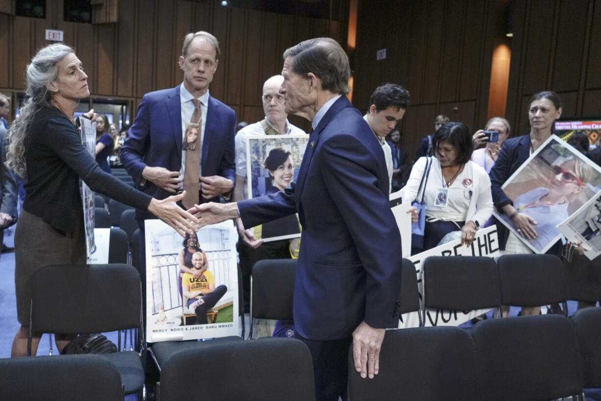 Sen. Richard Blumenthal, D-Conn., center, visits with family members of victims of Boeing plane crashes after a Senate Homeland Security Subcommittee on Investigations hearing on Capitol Hill Tuesday, June 18, 2024, in Washington.
