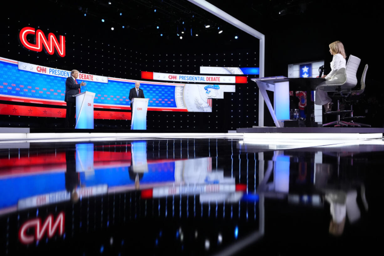 President Joe Biden, right, and Republican presidential candidate former President Donald Trump, left, during a presidential debate hosted by CNN, Thursday, June 27, 2024, in Atlanta. On the far right is CNN moderator Dana Bash.