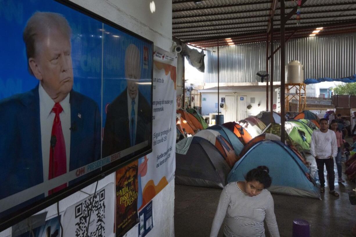 Migrants waiting to apply for asylum watch the presidential debate in a shelter for migrants, Thursday, June 27, 2024, in Tijuana, Mexico.