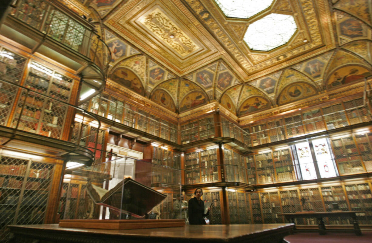 A 1455 Biblia Latina by Johannes Gutenberg and Johann Fust, foreground left, is on display inside the personal library of Pierpont Morgan, at the Morgan Library and Museum in New York. Three times per year, a library curator turns the page.