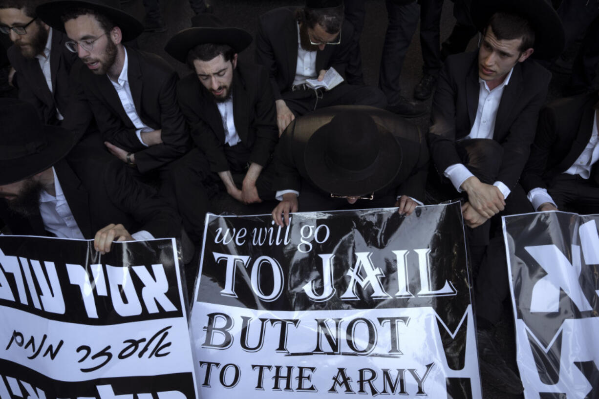 Ultra-Orthodox Jewish men block a highway as they take part in a protest against army recruitment in Bnei Brak, Israel, Thursday, June 27, 2024. Israel&rsquo;s Supreme Court unanimously ordered the government to begin drafting ultra-Orthodox Jewish men into the army, a landmark ruling seeking to end a system that has allowed them to avoid enlistment into compulsory military service.