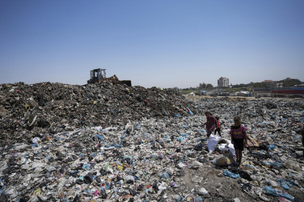 Palestinians sort through trash at a landfill in Nuseirat refugee camp, Gaza Strip, Thursday, June 20, 2024. Israel&rsquo;s war in Gaza has decimated the strip&rsquo;s sanitation system while simultaneously displacing the vast majority of the population, leaving many Palestinians living in tent camps nearby water contaminated with sewage and growing piles of garbage.