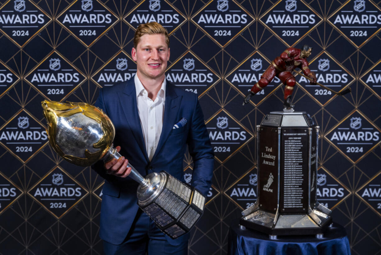 Colorado Avalanche forward Nathan MacKinnon stands with his trophies as the recipient of the Hart Memorial Trophy, left, and Ted Lindsay Award at hockey&rsquo;s NHL Awards, Thursday, June 27, 2024, in Las Vegas. (AP Photo/L.E.
