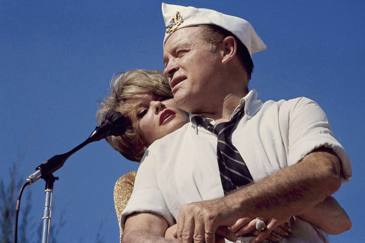 FILE - Bob Hope and Janis Paige hug during the annual Christmas show in Saigon, Vietnam, Dec. 25, 1964. Paige, a popular actor in Hollywood and in Broadway musicals and comedies who danced with Fred Astaire, toured with Bob Hope and continued to perform into her 80s, has died Sunday, June 2, 2024, of natural causes at her Los Angeles home, longtime friend Stuart Lampert said Monday, June 3.