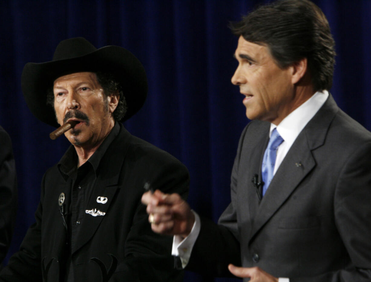 FILE - Texas gubernatorial candidate Kinky Friedman, left, listens as Gov. Rick Perry makes a comment during an on-air debate in Dallas on Oct. 6, 2006. Friedman, the singer, songwriter, satirist and novelist who also dabbled in Texas politics with a campaign for governor, died Thursday at his family&rsquo;s Texas ranch near San Antonio. He was 79. (AP Photo/Smiley N.
