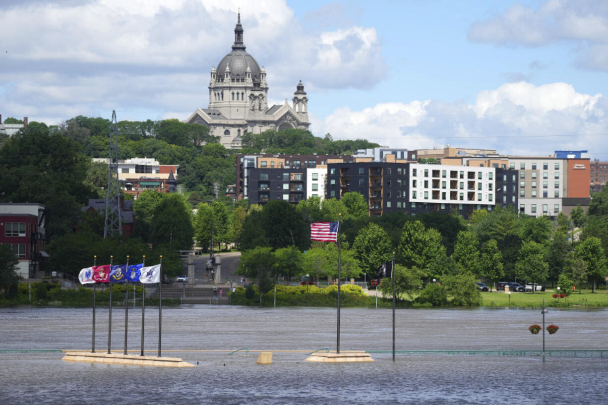 Rising water from the Mississippi River envelopes the riverbank, Wednesday, June 26, 2024, at Harriet Island Regional Park in St. Paul, Minn.