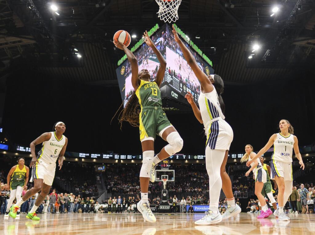 Seattle Storm's Ezi Magbegor (13) finds room in the lane to score over Dallas Wings' Teaira McCowan, center right, in the first quarter of a WNBA basketball game Saturday, June 29, 2024, in Seattle.